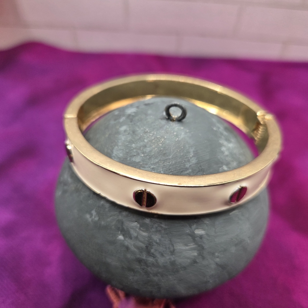 910. Gold Tone and White Clamper Bracelet